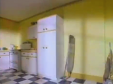 Koolaid Man bursts through the wall of a kitchen