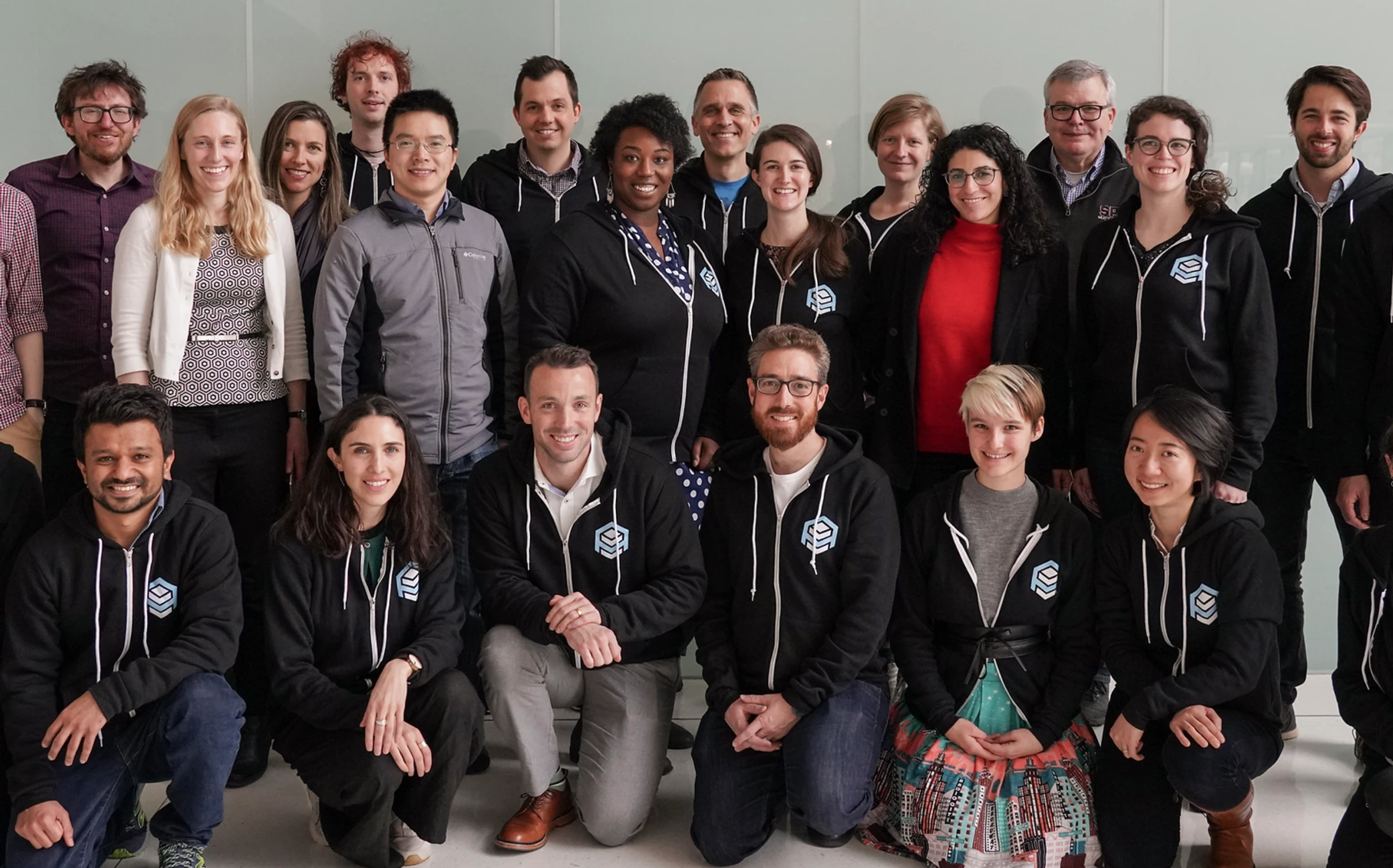 Group photo of the 2019 Assembly cohort wearing matching hoodies